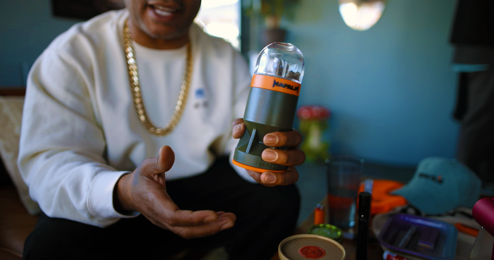 Person holding up a Napalm-branded flower bomb product during a customer testimonial video shoot.